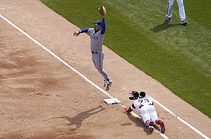 Apr 25, 2021; Chicago, Illinois, USA; Chicago White Sox designated hitter Yermin Mercedes (73) slides safely into first base with an infield single as Texas Rangers first baseman Nate Lowe (30) takes the throw during the second inning at Guaranteed Rate Field. Mandatory Credit: David Banks-USA TODAY Sports