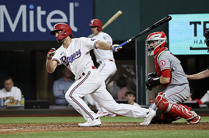 Apr 27, 2021; Arlington, Texas, USA;  Texas Rangers third baseman Charlie Culberson (2) hits an rbi single during the fourth inning against the Los Angeles Angels at Globe Life Field. Mandatory Credit: Kevin Jairaj-USA TODAY Sports