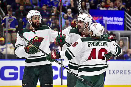 Apr 8, 2022; St. Louis, Missouri, USA;  Minnesota Wild defenseman Jacob Middleton (5) celebrates with defenseman Jared Spurgeon (46) and left wing Jordan Greenway (18) after scoring against the St. Louis Blues during the third period at Enterprise Center. Mandatory Credit: Jeff Curry-USA TODAY Sports