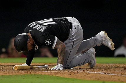 Jun 29, 2022; Anaheim, California, USA;  Chicago White Sox third baseman Yoan Moncada (10) hits the ground after fouling a ball off his foot in the eighth inning against the Los Angeles Angels at Angel Stadium. Mandatory Credit: Jayne Kamin-Oncea-USA TODAY Sports