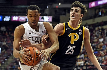 Feb 11, 2023; Tallahassee, Florida, USA; Pittsburgh Panthers forward Guillermo Diaz Graham (25) fights for a rebound against Florida State Seminoles guard Matthew Cleveland (35) during the second half at Donald L. Tucker Center. Mandatory Credit: Melina Myers-USA TODAY Sports