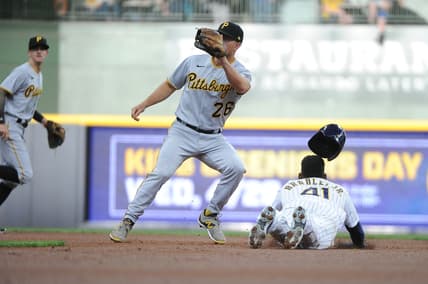 Apr 17, 2021; Milwaukee, Wisconsin, USA; Milwaukee Brewers center fielder Jackie Bradley Jr. (41) slides safely into second base ahead of the tag by Pittsburgh Pirates second baseman Adam Frazier (26) in the first inning at American Family Field. Mandatory Credit: Michael McLoone-USA TODAY Sports
