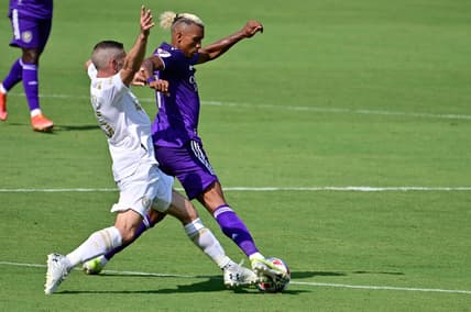 Apr 17, 2021; Orlando, Florida, USA; Orlando City SC forward Nani (17) and Atlanta United FC midfielder Lisandro Lopez (15) fight for the ball during the second half at Orlando City Stadium. Mandatory Credit: Douglas DeFelice-USA TODAY Sports
