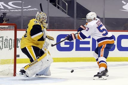 May 18, 2021; Pittsburgh, Pennsylvania, USA;  Pittsburgh Penguins goaltender Tristan Jarry (35) makes a save against New York Islanders center Casey Cizikas (53) during the first period in game two of the first round of the 2021 Stanley Cup Playoffs at PPG Paints Arena. Mandatory Credit: Charles LeClaire-USA TODAY Sports
