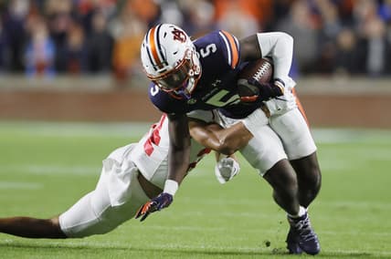 Oct 30, 2021; Auburn, Alabama, USA; Auburn Tigers wide receiver Kobe Hudson (5) is tackled by Mississippi Rebels defensive back Deane Leonard (24) during the first quarter at Jordan-Hare Stadium.  Mandatory Credit: John Reed-USA TODAY Sports