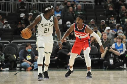 Feb 1, 2022; Milwaukee, Wisconsin, USA;  Washington Wizards guard Aaron Holiday (4) guards Milwaukee Bucks guard Jrue Holiday (21) in the second half at Fiserv Forum. Mandatory Credit: Michael McLoone-USA TODAY Sports