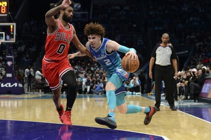 Feb 9, 2022; Charlotte, North Carolina, USA; Charlotte Hornets guard LaMelo Ball (2) controls the ball while defended by Chicago Bulls guard Coby White (0) during the first half at the Spectrum Center. Mandatory Credit: Sam Sharpe-USA TODAY Sports