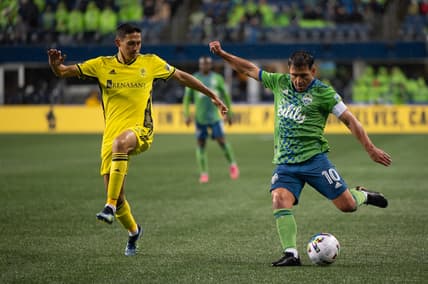 Feb 27, 2022; Seattle, Washington, USA; Seattle Sounders midfielder Nicol s Lodeiro (10) crosses the ball while being defended by Nashville SC midfielder Sean Davis (54) during the second half at Lumen Field. Nashville defeated Seattle 1-0. Mandatory Credit: Steven Bisig-USA TODAY Sports