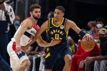 Feb 16, 2022; Indianapolis, Indiana, USA; Indiana Pacers guard Tyrese Haliburton (0) dribbles the ball while Washington Wizards guard Raul Neto (19) defends  in the first half at Gainbridge Fieldhouse. Mandatory Credit: Trevor Ruszkowski-USA TODAY Sports
