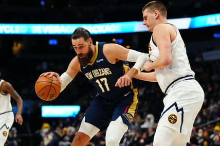Mar 6, 2022; Denver, Colorado, USA; New Orleans Pelicans center Jonas Valanciunas (17) drives to the basket against Denver Nuggets center Nikola Jokic (15) in the first quarter at Ball Arena. Mandatory Credit: Ron Chenoy-USA TODAY Sports