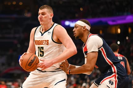 Mar 16, 2022; Washington, District of Columbia, USA;  Denver Nuggets center Nikola Jokic (15) moves the ball as Washington Wizards center Daniel Gafford (21) defends during the first half at Capital One Arena. Mandatory Credit: Tommy Gilligan-USA TODAY Sports