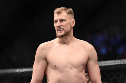 Mar 19, 2022; London, UK; Alexander Volkov (red gloves) and Tom Aspinall (blue gloves) during UFC Fight Night at O2 Arena. Mandatory Credit: Per Haljestam-USA TODAY Sports