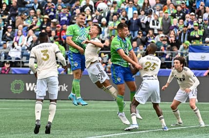Jun 18, 2022; Seattle, Washington, USA; Seattle Sounders forward Jordan Morris (13) heads the ball over Los Angeles FC forward Danny Musovski (29) during the first half at Lumen Field. Mandatory Credit: Steven Bisig-USA TODAY Sports