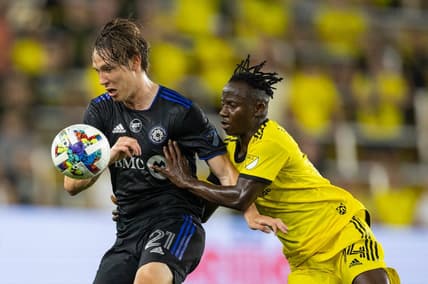 Aug 3, 2022; Columbus, Ohio, USA; CF Montreal midfielder Lassi Lappalainen (21) and Columbus Crew midfielder Yaw Yeboah (14) fight for the ball in the second half at Lower.com Field. Mandatory Credit: Trevor Ruszkowski-USA TODAY Sports