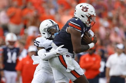 Sep 17, 2022; Auburn, Alabama, USA; Auburn Tigers quarterback T.J. Finley (1) is tackled by Penn State Nittany Lions cornerback Daequan Hardy (25) during the second quarter at Jordan-Hare Stadium. Mandatory Credit: John Reed-USA TODAY Sports