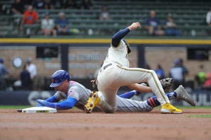 Sep 21, 2022; Milwaukee, Wisconsin, USA;  New York Mets center fielder Brandon Nimmo (9) slides into second base safely ahead of the tag from Milwaukee Brewers shortstop Willy Adames (27) in the first inning at American Family Field. Mandatory Credit: Michael McLoone-USA TODAY Sports