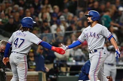 Sep 29, 2022; Seattle, Washington, USA; Texas Rangers second baseman Marcus Semien (2) is greeted by shortstop Josh Smith (47) after hitting a two run home run against the Seattle Mariners during the third inning at T-Mobile Park. Mandatory Credit: Steven Bisig-USA TODAY Sports