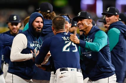 Sep 29, 2022; Seattle, Washington, USA; Seattle Mariners designated hitter Jesse Winker (27) and Julio Rodriguez celebrate with left fielder Dylan Moore (25) his run scored against the Texas Rangers during the eleventh inning at T-Mobile Park. Seattle defeated Texas 10-9. Mandatory Credit: Steven Bisig-USA TODAY Sports