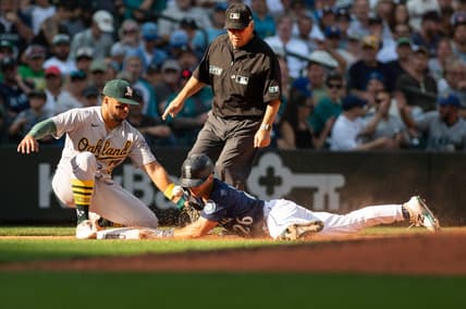 Oct 1, 2022; Seattle, Washington, USA; Seattle Mariners second baseman Adam Frazier (26) beats the throw to Oakland Athletics third baseman Vimael Machin (31) to steal third base during the seventh inning at T-Mobile Park. Mandatory Credit: Steven Bisig-USA TODAY Sports