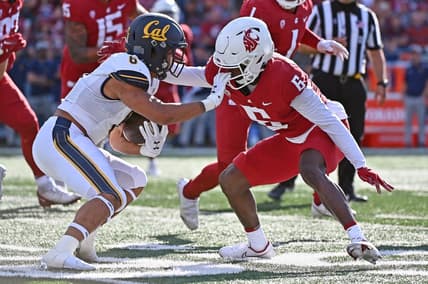 Oct 1, 2022; Pullman, Washington, USA; California Golden Bears running back Jaydn Ott, left, tries to stiff arm Washington State Cougars defensive back Chau Smith-Wade (6) in the first half at Gesa Field at Martin Stadium. Mandatory Credit: James Snook-USA TODAY Sports