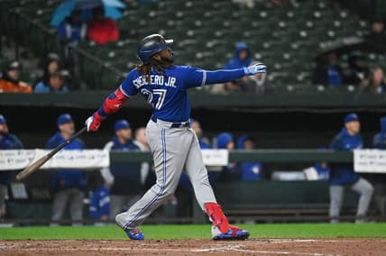 Oct 3, 2022; Baltimore, Maryland, USA; Toronto Blue Jays first baseman Vladimir Guerrero Jr. (27) hits a second inning solo home run against the Baltimore Orioles  at Oriole Park at Camden Yards. Mandatory Credit: Tommy Gilligan-USA TODAY Sports