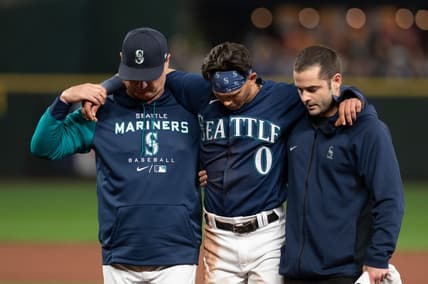 Oct 3, 2022; Seattle, Washington, USA; Seattle Mariners assistant athletic trainer Kevin Orloski and head coach Scott Servais help right fielder Sam Haggerty (0) off the field after Haggerty was injured sliding into second base during the ninth inning against the Detroit Tigers at T-Mobile Park. Detroit defeated Seattle 4-3. Mandatory Credit: Steven Bisig-USA TODAY Sports