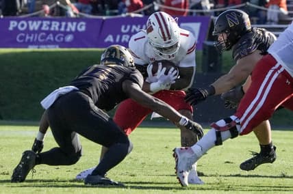 Wisconsin Badgers running back Chez Mellusi (1) is tackled by Northwestern Wildcats linebacker Xander Mueller (34) and Northwestern Wildcats defensive back Rod Heard II (24) during their game Saturday, Oct. 8, 2022, at Ryan Field in Evanston, Illinois.

Mjs Mjs 10082022 Uwfootball Badgers Ec267529