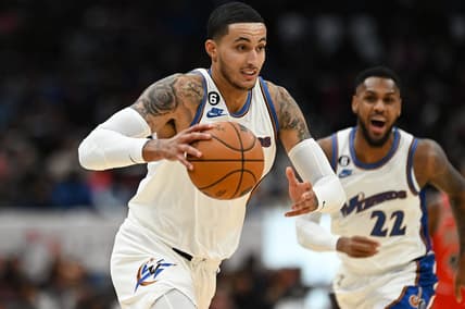 Oct 21, 2022; Washington, District of Columbia, USA;  Washington Wizards forward Kyle Kuzma (33) makes a move to the basket as guard Monte Morris (22) reacts during the first half against the Chicago Bulls at Capital One Arena. Mandatory Credit: Tommy Gilligan-USA TODAY Sports
