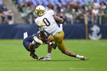 Nov 12, 2022; Baltimore, Maryland, USA;  Notre Dame Fighting Irish wide receiver Braden Lenzy (0) toss a Navy Midshipmen defender during the first quarter at M&T Bank Stadium. Mandatory Credit: Tommy Gilligan-USA TODAY Sports