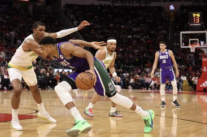 Dec 11, 2022; Houston, Texas, USA; Milwaukee Bucks forward Giannis Antetokounmpo (34) dribbles against Houston Rockets forward Jabari Smith Jr. (1) in the second quarter at Toyota Center. Mandatory Credit: Thomas B. Shea-USA TODAY Sports
