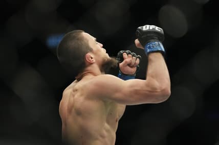 Mar 5, 2022; Las Vegas, Nevada, UNITED STATES; Umar Nurmagomedov (blue gloves) celebrates after defeating Brian Kelleher (not pictured) during UFC 272 at T-Mobile Arena. Mandatory Credit: Stephen R. Sylvanie-USA TODAY Sports