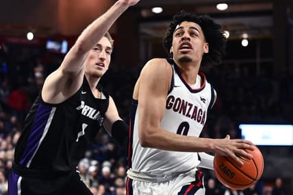 Jan 14, 2023; Spokane, Washington, USA; Gonzaga Bulldogs guard Julian Strawther (0) shoots the ball against Portland Pilots forward Moses Wood (1) in the first half at McCarthey Athletic Center. Mandatory Credit: James Snook-USA TODAY Sports