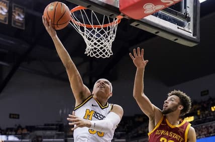 Jan 28, 2023; Columbia, Missouri, USA; Missouri Tigers forward Noah Carter (left) shoots the ball against Iowa State Cyclones guard Gabe Kalscheur (right) during the first half at Mizzou Arena. Mandatory Credit: Denny Medley-USA TODAY Sports