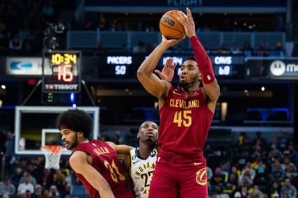 Feb 5, 2023; Indianapolis, Indiana, USA; Cleveland Cavaliers guard Donovan Mitchell (45) shoots the ball while  Indiana Pacers forward Aaron Nesmith (23) defends in the second half at Gainbridge Fieldhouse. Mandatory Credit: Trevor Ruszkowski-USA TODAY Sports