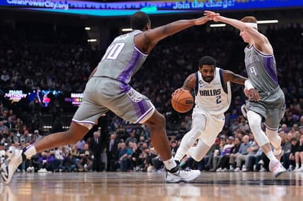 Feb 10, 2023; Sacramento, California, USA; Dallas Mavericks guard Kyrie Irving (2) dribbles between Sacramento Kings guard Kevin Huerter (9) and forward Harrison Barnes (40) in the second quarter at the Golden 1 Center. Mandatory Credit: Cary Edmondson-USA TODAY Sports