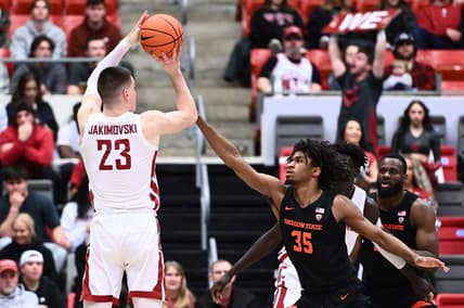Feb 16, 2023; Pullman, Washington, USA; Washington State Cougars forward Andrej Jakimovski (23) shoots the ball against Oregon State Beavers forward Glenn Taylor Jr. (35) in the first half at Friel Court at Beasley Coliseum. Mandatory Credit: James Snook-USA TODAY Sports