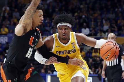 Jan 28, 2023; Pittsburgh, Pennsylvania, USA; Pittsburgh Panthers forward Blake Hinson (right) drives to the basket against Miami (Fl) Hurricanes guard Jordan Miller (11) during the first half at the Petersen Events Center. Mandatory Credit: Charles LeClaire-USA TODAY Sports