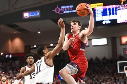 Feb 25, 2023; Spokane, Washington, USA; St. Mary's Gaels guard Alex Ducas (44) shoots the ball against Gonzaga Bulldogs guard Nolan Hickman (11) in the second half at McCarthey Athletic Center. Gonzaga won 77-68. Mandatory Credit: James Snook-USA TODAY Sports