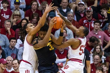 Mar 5, 2023; Bloomington, Indiana, USA; Michigan Wolverines forward Tarris Reed Jr. (32) looks to pass the ball while Indiana Hoosiers forward Malik Reneau (5) and  guard Tamar Bates (53) defend in the first half at Simon Skjodt Assembly Hall. Mandatory Credit: Trevor Ruszkowski-USA TODAY Sports