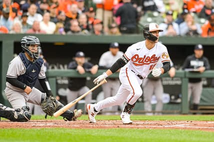 Apr 7, 2023; Baltimore, Maryland, USA; Baltimore Orioles second baseman Adam Frazier (12) hits a  second inning rbi single against the New York Yankees at Oriole Park at Camden Yards. Mandatory Credit: Tommy Gilligan-USA TODAY Sports