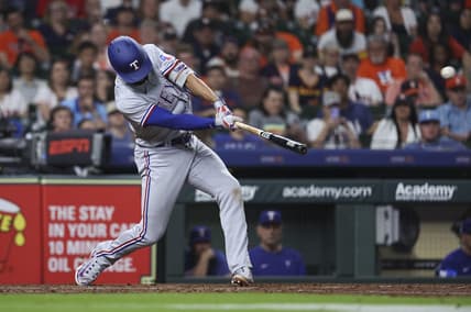 Apr 16, 2023; Houston, Texas, USA; Texas Rangers second baseman Marcus Semien (2) hits a grand slam during the seventh inning against the Houston Astros at Minute Maid Park. Mandatory Credit: Troy Taormina-USA TODAY Sports