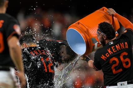 Apr 21, 2023; Baltimore, Maryland, USA;  Baltimore Orioles second baseman Adam Frazier (12)  gets water dumped on him by left fielder Ryan McKenna (26) after defeating against the Detroit Tigers   at Oriole Park at Camden Yards. Mandatory Credit: Tommy Gilligan-USA TODAY Sports