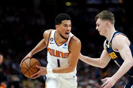 May 1, 2023; Denver, Colorado, USA; Phoenix Suns guard Devin Booker (1) and Denver Nuggets guard Christian Braun (0)  in the first half during game two of the 2023 NBA playoffs at Ball Arena. Mandatory Credit: Ron Chenoy-USA TODAY Sports