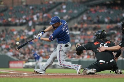May 26, 2023; Baltimore, Maryland, USA;  Texas Rangers shortstop Corey Seager (5) hits a fourth inning grand slam off Baltimore Orioles starting pitcher Grayson Rodriguez (30) at Oriole Park at Camden Yards. Mandatory Credit: Tommy Gilligan-USA TODAY Sports