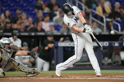Jun 22, 2023; Miami, Florida, USA;  Miami Marlins first baseman Garrett Cooper (26) hits a double in the second inning against the Pittsburgh Pirates at loanDepot Park. Mandatory Credit: Jim Rassol-USA TODAY Sports