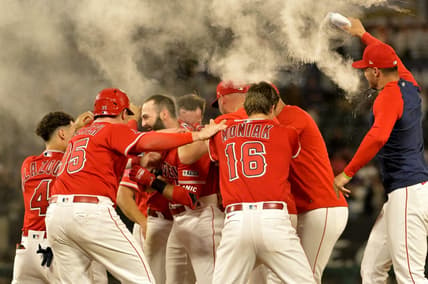 Jul 17, 2023; Anaheim, California, USA;  Los Angeles Angels second baseman Michael Stefanic (38) is mobbed after a pinch hit RBI single in the 10th inning to defeat the New York Yankees at Angel Stadium. Mandatory Credit: Jayne Kamin-Oncea-USA TODAY Sports