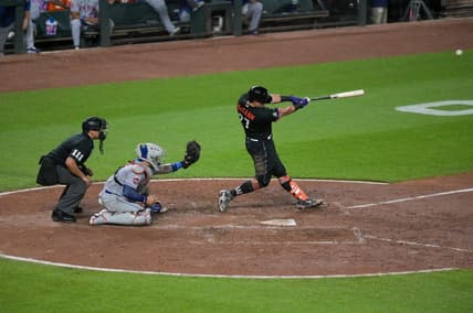 Aug 4, 2023; Baltimore, Maryland, USA;  Baltimore Orioles catcher James McCann (27)hits a two run double during the sixth inning against the New York Mets at Oriole Park at Camden Yards. Mandatory Credit: Tommy Gilligan-USA TODAY Sports