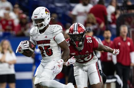 Sep 16, 2023; Indianapolis, Indiana, USA; Louisville Cardinals running back Jawhar Jordan (25) runs for a touchdown against Indiana Hoosiers defensive back Louis Moore (20) in the second quarter at Lucas Oil Stadium. Mandatory Credit: Trevor Ruszkowski-USA TODAY Sports