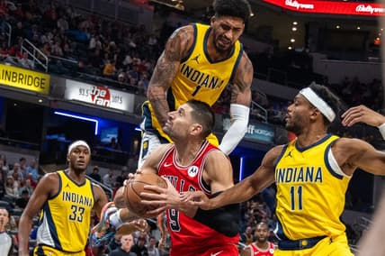 Oct 30, 2023; Indianapolis, Indiana, USA; Chicago Bulls center Nikola Vucevic (9) shoots the ball while Indiana Pacers forward Obi Toppin (1) and forward Bruce Brown (11) defend in the first quarter at Gainbridge Fieldhouse. Mandatory Credit: Trevor Ruszkowski-USA TODAY Sports