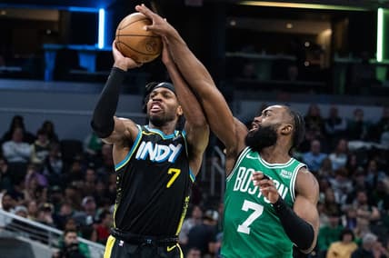 Jan 6, 2024; Indianapolis, Indiana, USA; Boston Celtics guard Jaylen Brown (7) blocks a shot by Indiana Pacers guard Buddy Hield (7) in the second half at Gainbridge Fieldhouse. Mandatory Credit: Trevor Ruszkowski-USA TODAY Sports